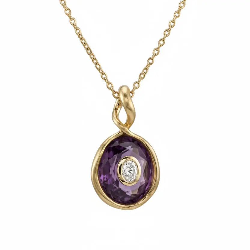 Gold necklace with a purple gemstone pendant on a white background