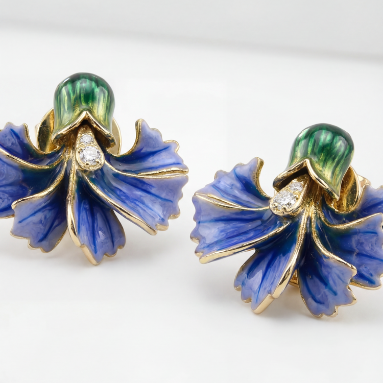 Pair of blue floral earrings with gold accents on a white background